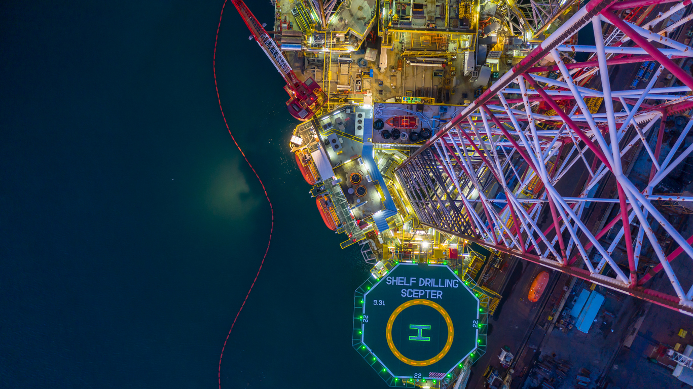 Aerial view offshore jack up rig at night, Offshore oil rig drilling platform.